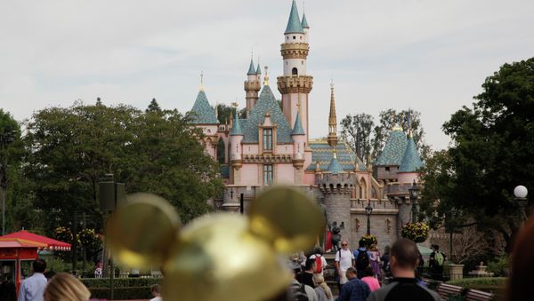 People walk toward the Sleeping Beauty's Castle in the background at Disneyland, Thursday, Jan. 22, 2015, in Anaheim, Calif - Sputnik International