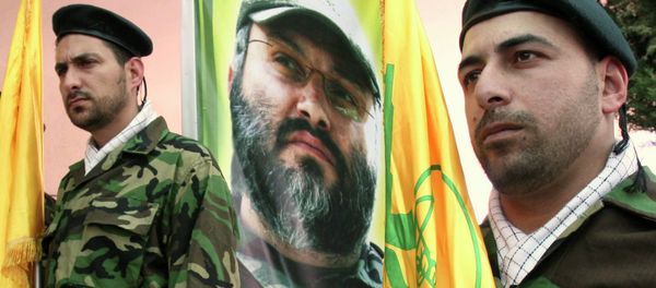 Hezbollah members stand guard in front of a picture of assassinated Hezbollah top commander Imad Imad Mughniyah Hezbollah members stand guard in front of a picture of assassinated Hezbollah top commander Imad Imad Mughniyah - Sputnik International