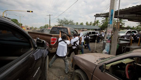 In this file photo, the Self-Defense Council of Michoacan (CAM) engage in a firefight as they try to flush out alleged members of the Knights Templar drug cartel from Nueva Italia, Mexico - Sputnik International