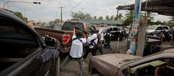 In this file photo, the Self-Defense Council of Michoacan (CAM) engage in a firefight as they try to flush out alleged members of the Knights Templar drug cartel from Nueva Italia, Mexico - Sputnik International