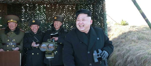 North Korean leader Kim Jong Un (R) laughs as he watches a drill by the Korean People's Army (KPA) for hitting enemy naval target at undisclosed location in this undated photo released by North Korea's Korean Central News Agency (KCNA) in Pyongyang January 31, 2015 - Sputnik International