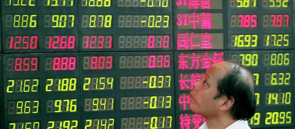 An investor looks at a stock price monitor at a private securities company - Sputnik International