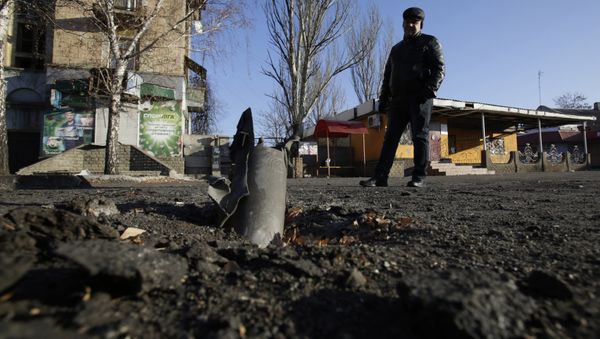 A man looks at Grad rocket louncher system after shelling November 23, 2014 in eastern Ukrainian city of Debalcevo A man looks at Grad rocket louncher system after shelling November 23, 2014 in eastern Ukrainian city of Debalcevo - Sputnik International