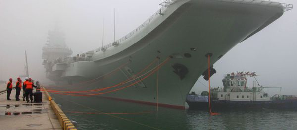 China's first aircraft carrier, the Liaoning, is anchored in the northern port in Qingdao, east China's Shandong Province, Wednesday, Feb. 27, 2013 - Sputnik International