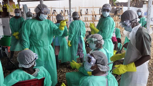 Health care workers inside a USAID-funded Ebola clinic with their Ebola virus protective gear in Liberia Health care workers inside a USAID-funded Ebola clinic with their Ebola virus protective gear in Liberia - Sputnik International