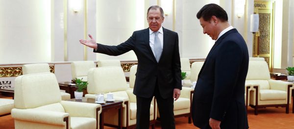 Russian Foreign Minister Sergey Lavrov, left, gestures to Chinese President Xi Jinping as Russian delegation members arrive for a meeting at the Great Hall of the People in Beijing Monday, Feb. 2, 2015 Russian Foreign Minister Sergey Lavrov, left, gestures to Chinese President Xi Jinping as Russian delegation members arrive for a meeting at the Great Hall of the People in Beijing Monday, Feb. 2, 2015 - Sputnik International