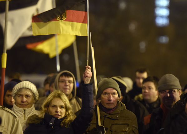 Anti-Islam protesters hold German flags during a BERGIDA rally, a local copycat of Dresden's right-wing populist movement PEGIDA (Patriotic Europeans Against the Islamisation of the Occident), at Alexander Platz in Berlin, eastern Germany - Sputnik International