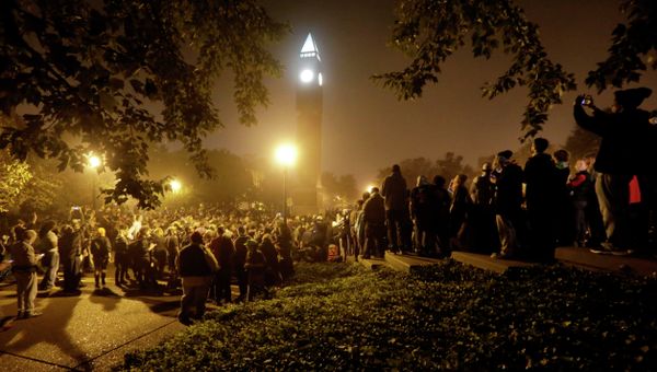 Protesters gather around the St. Louis University campus clock tower after a march through the streets of St. Louis, protesting against the recent shootings of two young black men by law enforcement officers, early Monday, Oct. 13, 2014. - Sputnik International
