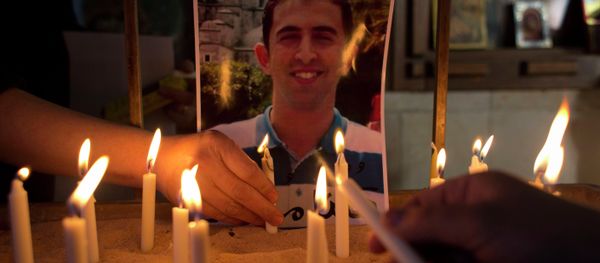 Two Jordanian women light candles next to a picture of Jordanian pilot Lt. Muath al-Kaseasbeh, who was murdered by Islamic State militants. Two Jordanian women light candles next to a picture of Jordanian pilot Lt. Muath al-Kaseasbeh, who was murdered by Islamic State militants. - Sputnik International