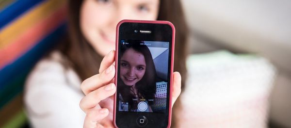 A teenage girl taking a picture of herself on her smartphone A teenage girl taking a picture of herself on her smartphone - Sputnik International