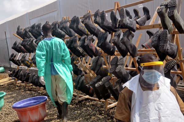 Health care workers walk past boots that were washed to prevent the spread of the Ebola virus inside a USAID, funded Ebola clinic in Monrovia, Liberia, Friday, Jan. 30, 2015. The World Health Organization says officials are now focused on ending the biggest-ever Ebola outbreak rather than just slowing the virus’ spread. Health care workers walk past boots that were washed to prevent the spread of the Ebola virus inside a USAID, funded Ebola clinic in Monrovia, Liberia, Friday, Jan. 30, 2015. The World Health Organization says officials are now focused on ending the biggest-ever Ebola outbreak rather than just slowing the virus’ spread. - Sputnik International