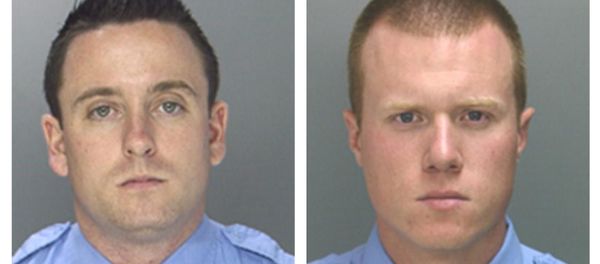 Officers Sean McKnight, left, and Kevin Robinson are shown. The two officers face brutality charges after prosecutors say they knocked a man off a scooter and beat him so severely another officer thought the bloodied man had been shot. They were charged Thursday, Feb. 5, 2015 with assault, criminal conspiracy and reckless endangerment. They're also charged with lying about the May 2013 incident. Officers Sean McKnight, left, and Kevin Robinson are shown. The two officers face brutality charges after prosecutors say they knocked a man off a scooter and beat him so severely another officer thought the bloodied man had been shot. They were charged Thursday, Feb. 5, 2015 with assault, criminal conspiracy and reckless endangerment. They're also charged with lying about the May 2013 incident. - Sputnik International