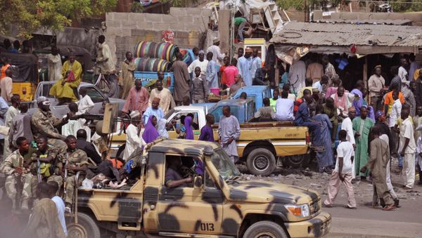 In this file photo taken Tuesday, Jan. 27, 2015, Nigerian Soldiers, left, pass by on the back of a armed truck as they patrol at a local market after recent violence in surrounding areas at Maiduguri, Nigeria - Sputnik International