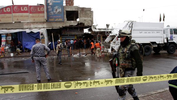 A member of the Iraqi security forces walks past the site of a bomb attack in Baghdad February 7, 2015 A member of the Iraqi security forces walks past the site of a bomb attack in Baghdad February 7, 2015 - Sputnik International