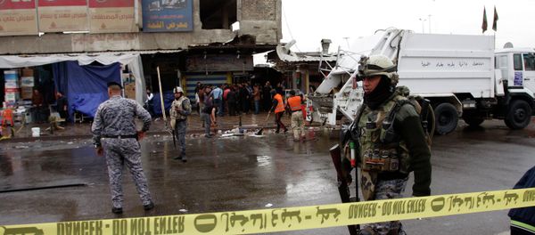 A member of the Iraqi security forces walks past the site of a bomb attack in Baghdad February 7, 2015 A member of the Iraqi security forces walks past the site of a bomb attack in Baghdad February 7, 2015 - Sputnik International