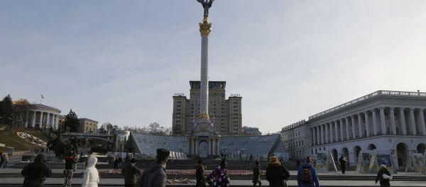 Ukrainians walking past candles in the shape of the national emblem of Ukraine on Independence Square in Kiev, Ukraine - Sputnik International