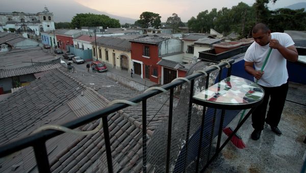 A waiter sweeps the ash covered terrace of a restaurant, from the eruption of the Fuego Volcano at Antigua Guatemala, Saturday, Feb. 7, 2015 A waiter sweeps the ash covered terrace of a restaurant, from the eruption of the Fuego Volcano at Antigua Guatemala, Saturday, Feb. 7, 2015 - Sputnik International