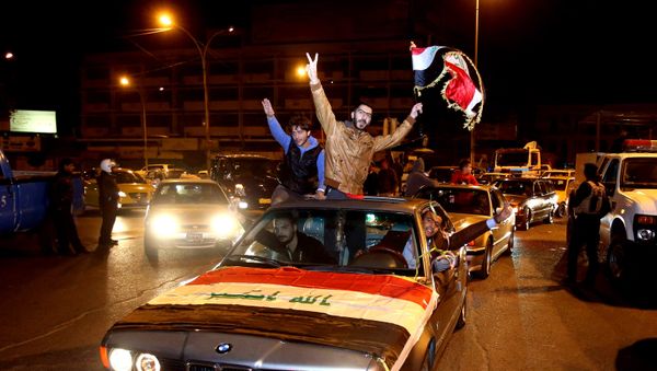 In this Saturday, Feb. 7, 2015 photo, Iraqis celebrate after the lifting of the night-time curfew at Tahrir Square in Baghdad, Iraq In this Saturday, Feb. 7, 2015 photo, Iraqis celebrate after the lifting of the night-time curfew at Tahrir Square in Baghdad, Iraq - Sputnik International