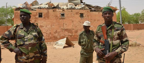 Nigerien soldiers stand near a damaged building in an army base in Agadez, northern Niger on May 26, 2013 Nigerien soldiers stand near a damaged building in an army base in Agadez, northern Niger on May 26, 2013 - Sputnik International