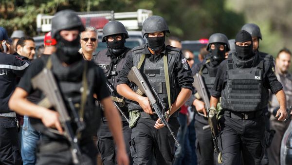 Members of the Tunisian National Guard take positions as they secure the scene of a shooting in the Oued Ellil suburb of Tunis, Tunisia, Thursday, Oct. 23, 2014 - Sputnik International
