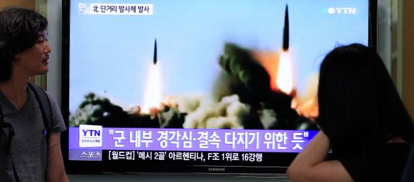 People watch a TV news program showing the missile launch conducted by North Korea, at Seoul Railway Station in Seoul, South Korea, Thursday, June 26, 2014 - Sputnik International