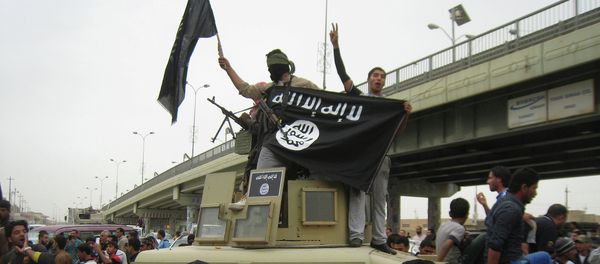 In this file photo, Islamic State group militants hold up their flag as they patrol in a commandeered Iraqi military vehicle in Fallujah, 40 miles (65 kilometers) west of Baghdad, Iraq In this file photo, Islamic State group militants hold up their flag as they patrol in a commandeered Iraqi military vehicle in Fallujah, 40 miles (65 kilometers) west of Baghdad, Iraq - Sputnik International