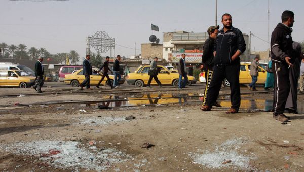 People gather at the site of a suicide bombing attack in the Shi'ite neighborhood of Kadhimiya in Baghdad February 9, 2015 - Sputnik International