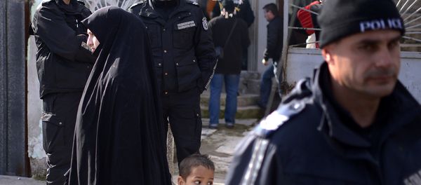 Policemen stand guard, during a search operation of a house in the Roma suburb in the city of Pazardjik, South West Bulgaria, on November 25, 2014 Policemen stand guard, during a search operation of a house in the Roma suburb in the city of Pazardjik, South West Bulgaria, on November 25, 2014 - Sputnik International