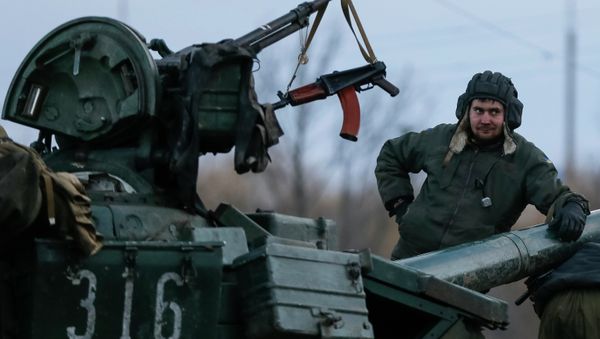 A Ukrainian serviceman stands on a tank near Artemivsk, eastern Ukraine, February 8, 2015 - Sputnik International