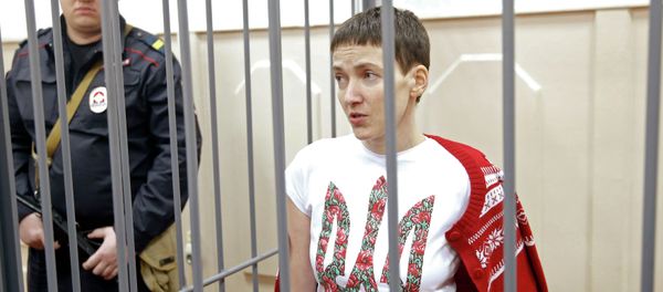 Ukrainian army pilot Nadezhda (Nadia) Savchenko looks out from a defendant's cage during a hearing at the Basmanny district court in Moscow February 10, 2015 - Sputnik International