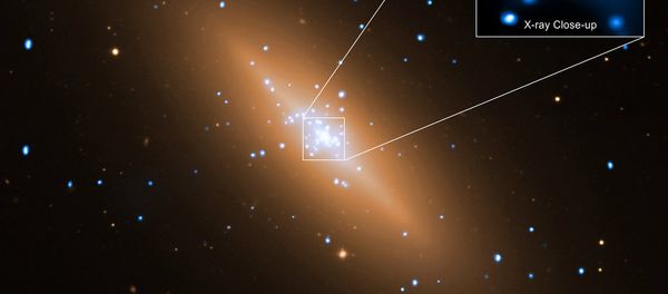 The galaxy NGC 3115 is shown here in a composite image of data from NASA's Chandra X-ray Observatory and the European Southern Observatory's Very Large Telescope (VLT). Using the Chandra image, the flow of hot gas toward the supermassive black hole in the center of this galaxy has been imaged. - Sputnik International