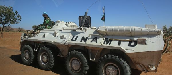 A member of the UN-African Union mission in Darfur (UNAMID) sits on an armoured personnel carrier patrolling near the city of Nyala in Sudan's Darfur A member of the UN-African Union mission in Darfur (UNAMID) sits on an armoured personnel carrier patrolling near the city of Nyala in Sudan's Darfur - Sputnik International