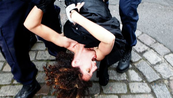 A Femen activist is taken away by police officers as she protests Tuesday, Feb. 10, 2015 in front of the Lille courthouse in Lille, northern France, where Dominique Strauss-Kahn goes on trial for sex charges in France. A Femen activist is taken away by police officers as she protests Tuesday, Feb. 10, 2015 in front of the Lille courthouse in Lille, northern France, where Dominique Strauss-Kahn goes on trial for sex charges in France. - Sputnik International