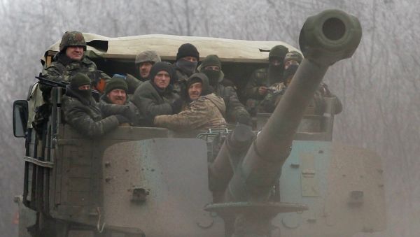 Ukrainian government soldiers ride on a vehicle on the road between the towns of Dabeltseve and Artemivsk, Ukraine, Saturday, Feb. 14, 2015 Ukrainian government soldiers ride on a vehicle on the road between the towns of Dabeltseve and Artemivsk, Ukraine, Saturday, Feb. 14, 2015 - Sputnik International