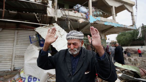 In this Tuesday, Nov. 25, 2014 file photo, an Iraqi man reacts at the site of a car bomb explosion, in the Shaab neighborhood of Baghdad, Iraq in a crowded marketplace that killed and wounded civilians - Sputnik International