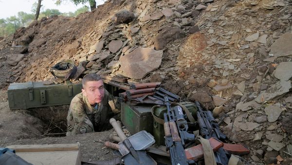 A Ukrainian army soldier examines his shelter at a position in Debaltsevo, Donetsk region, Ukraine, Friday, Sept. 12, 2014 - Sputnik International