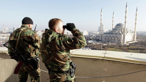 Members of law enforcement forces stand guard during a rally to protest against satirical cartoons of prophet Mohammad, near the Heart of Chechnya mosque in Grozny, Chechnya January 19, 2015 - Sputnik International