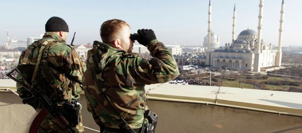Members of law enforcement forces stand guard during a rally to protest against satirical cartoons of prophet Mohammad, near the Heart of Chechnya mosque in Grozny, Chechnya January 19, 2015 - Sputnik International