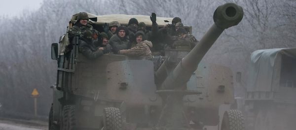 Members of the Ukrainian armed forces ride on a military vehicle near Artemivsk, eastern Ukraine February 14, 2015 Members of the Ukrainian armed forces ride on a military vehicle near Artemivsk, eastern Ukraine February 14, 2015 - Sputnik International