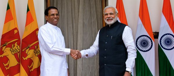 Sri Lanka’s President Maithripala Sirisena, left, and Indian Prime Minister Narendra Modi shake hands as they pose for photos before their meeting in New Delhi, India, Monday, Feb. 16, 2015 - Sputnik International