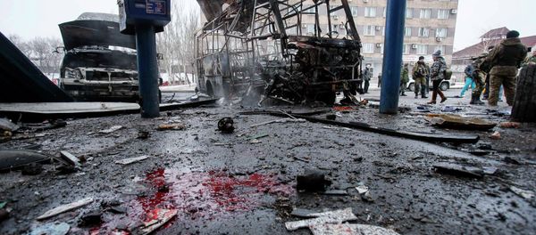 Destroyed vehicles, debris and blood on the ground are seen at a bus station after shelling in Donetsk, February 11, 2015 - Sputnik International
