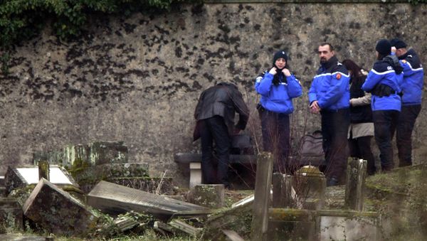 Police officers investigate the site of defaced tombstones at the Jewish cemetery of Sarre-Union, eastern France, Monday, Feb. 16, 2015 Police officers investigate the site of defaced tombstones at the Jewish cemetery of Sarre-Union, eastern France, Monday, Feb. 16, 2015 - Sputnik International