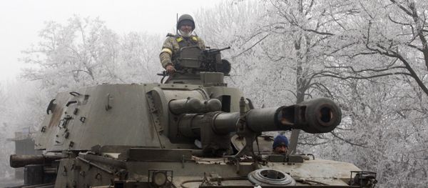 Ukrainian servicemen patrol with a self-propelled artillery gun on the road between Artemivsk and Debaltseve, in the region of Donetsk, on February 15, 2015 Ukrainian servicemen patrol with a self-propelled artillery gun on the road between Artemivsk and Debaltseve, in the region of Donetsk, on February 15, 2015 - Sputnik International