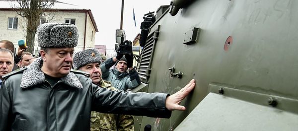 Ukraine's President Petro Poroshenko inspects a British Saxon military vehicle for its bullet proof capabilities at the National Guard Training Center in Novy Petrivtsy, Ukraine, Friday, Feb. 13, 2015 - Sputnik International