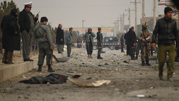 Afghan security personnel inspect the scene of a suicide attack on a European Union police vehicle along the Kabul-Jalalabad road in Kabul on January 5, 2015 - Sputnik International