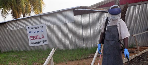 A health care worker sprays disinfectant outside a USAID, funded Ebola clinic in Monrovia, Liberia, Friday, Jan. 30, 2015 A health care worker sprays disinfectant outside a USAID, funded Ebola clinic in Monrovia, Liberia, Friday, Jan. 30, 2015 - Sputnik International