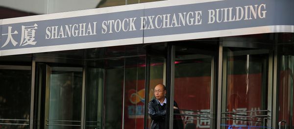 A man walks out of the Shanghai Stock Exchange building at the Pudong financial district in Shanghai - Sputnik International