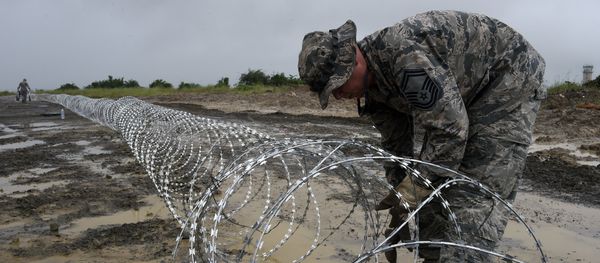 An US air Force soldier delimits with barbed wire the position of the next Ebola treatment center reserved for contaminated healthcare workers An US air Force soldier delimits with barbed wire the position of the next Ebola treatment center reserved for contaminated healthcare workers - Sputnik International