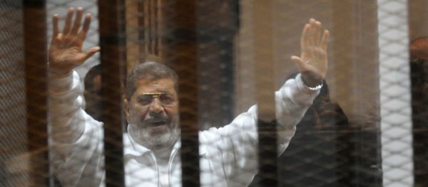 Egypt's deposed Islamist president Mohamed Morsi waves from inside the defendant’s cage during his trial at the police academy in Cairo on January 8, 2015 Egypt's deposed Islamist president Mohamed Morsi waves from inside the defendant’s cage during his trial at the police academy in Cairo on January 8, 2015 - Sputnik International