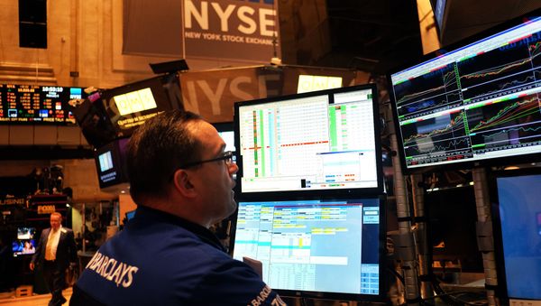 A trader works on the floor of the New York Stock Exchange (NYSE) on February 6, 2015, in New York - Sputnik International